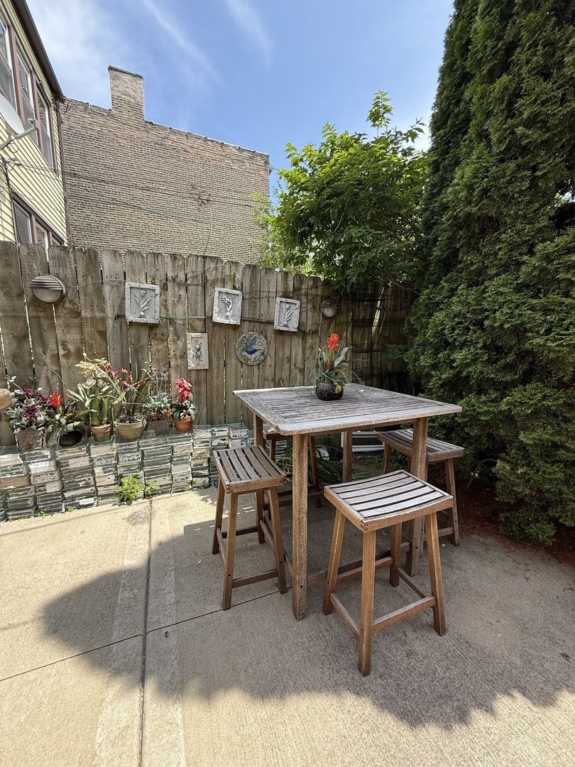 3721 West Belden Avenue, Unit 1 Chicago, IL 60647 - Photo 4 of 23 a patio with table and chairs