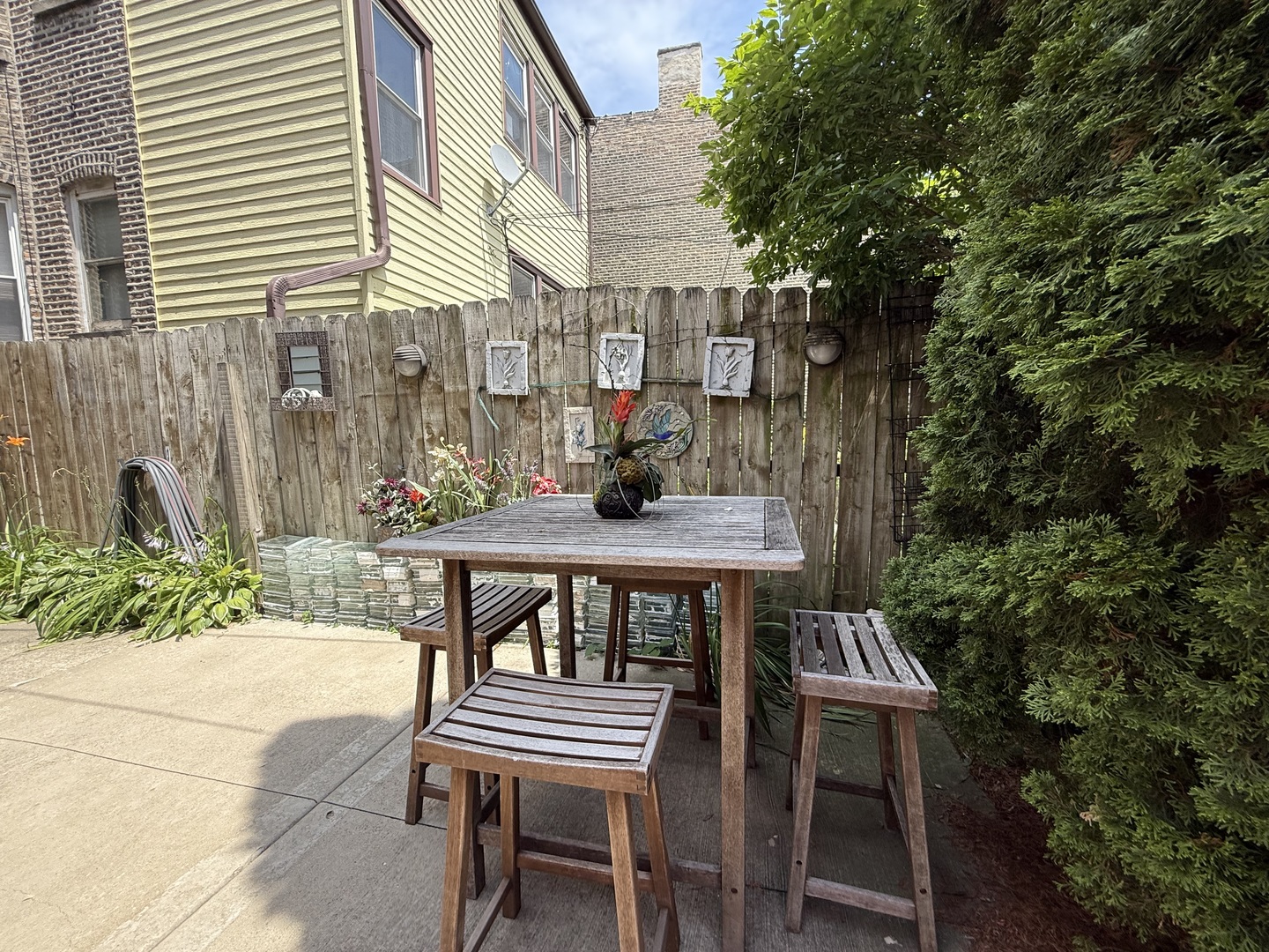 3721 West Belden Avenue, Unit 1 Chicago, IL 60647 - Photo 5 of 23 a view of a patio with table and chairs and potted plants