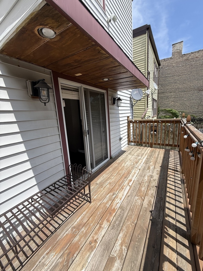 3721 West Belden Avenue, Unit 1 Chicago, IL 60647 - Photo 9 of 23 a view of a balcony with wooden floor and stairs