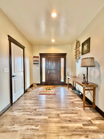 2101 Goose Ranch Road Vernal, UT 84078 - Photo 5 of 72 Inviting entryway featuring wood-finish flooring, a solid wood front door with sidelights, and recessed lighting