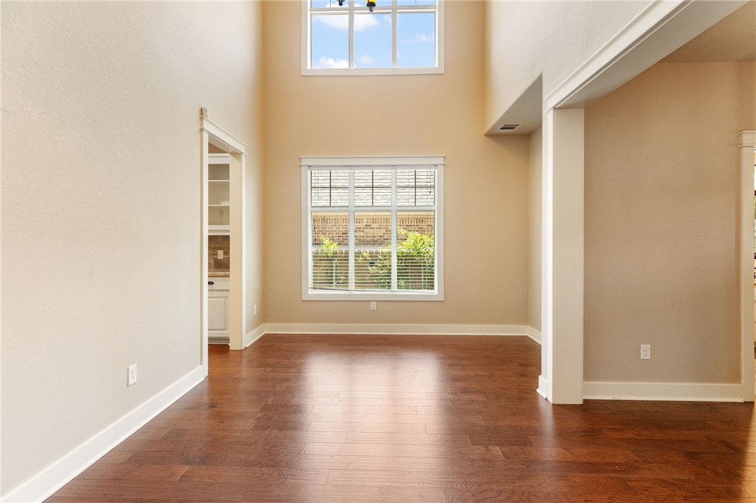 2136 Rockcliffe Loop College Station, TX 77845 - Photo 12 of 48 a view of an empty room with wooden floor and a window