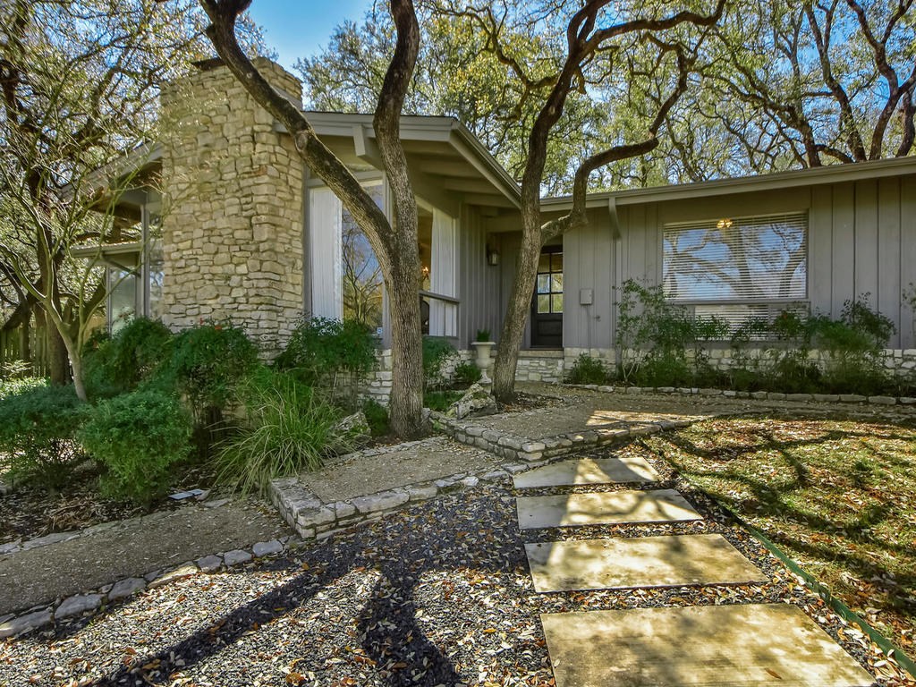 501 Honeycomb Ridge Austin, TX 78746 - Photo 1 of 1 a front view of a house with garden
