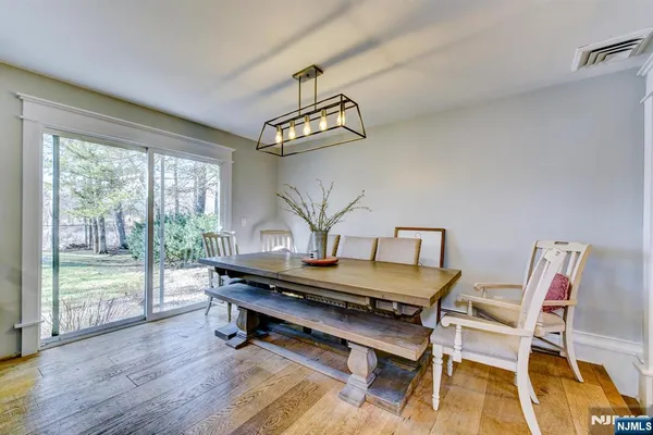 a view of a dining room with furniture wooden floor and a chandelier