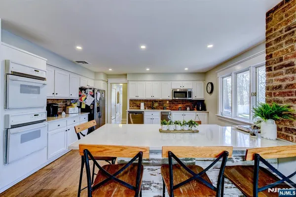 a view of a dining room with furniture and a kitchen