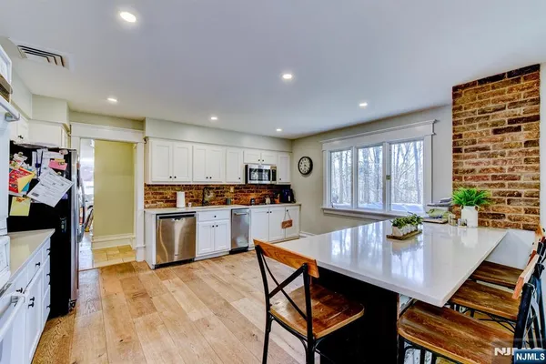 a living room with stainless steel appliances kitchen island granite countertop furniture and a kitchen view