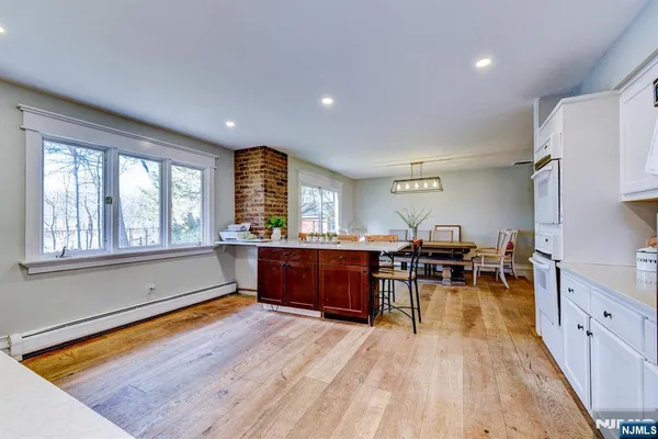 a living room with furniture a wooden floor and pool table