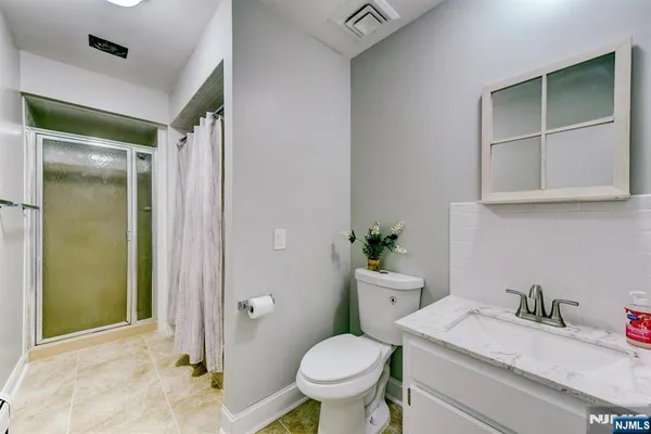 a bathroom with a granite countertop toilet sink and shower