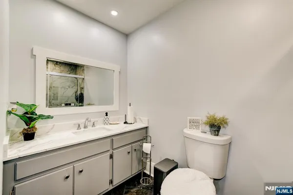 a bathroom with a toilet sink and mirror