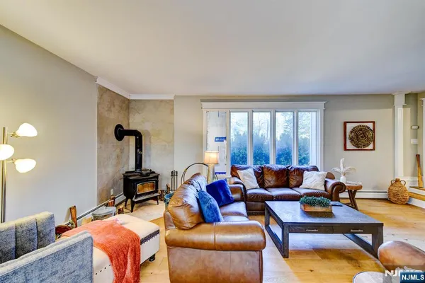 a living room with furniture and a floor to ceiling window