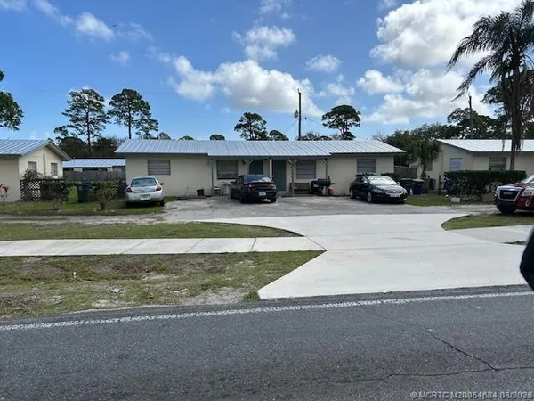 a view of a house with swimming pool and a yard in front of it