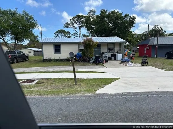 a front view of a house with a yard and a bike