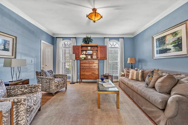a dining room with wooden floor a chandelier a wooden table and chairs