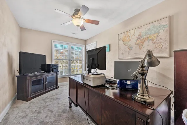 a living room with furniture a flat screen tv and a window