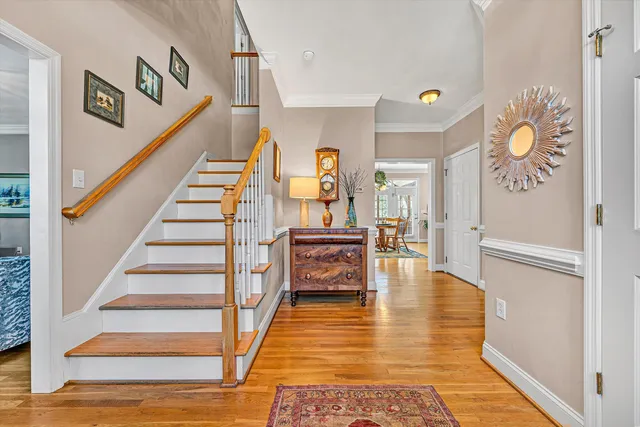 a kitchen with granite countertop wooden floors and white cabinets
