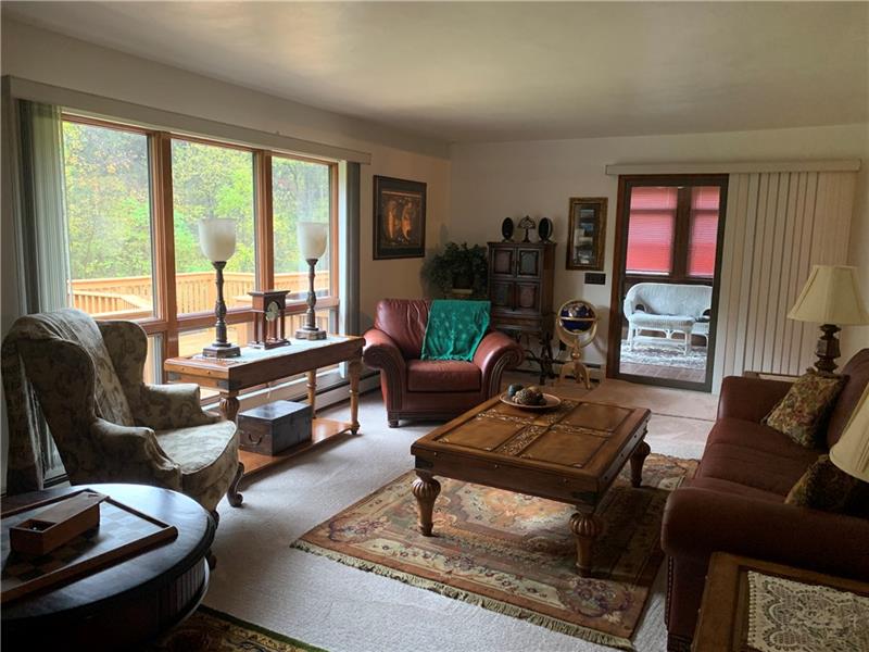 604 Browntown Road New Stanton, PA 15672 - Photo 13 of 22 Living room w/sunroom and large deck