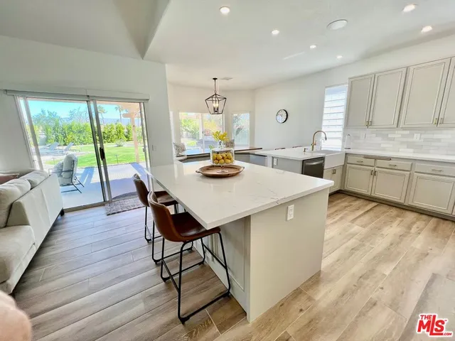 a view of a livingroom with kitchen and furniture