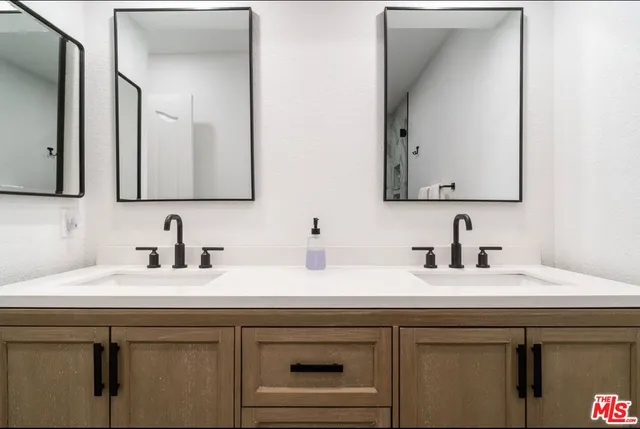 a view of a swimming pool with lawn chairs under an umbrella