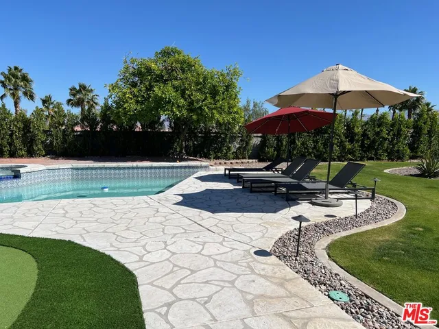 a sink with a stove and white cabinets