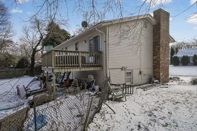 a view of balcony with chairs and wooden fence