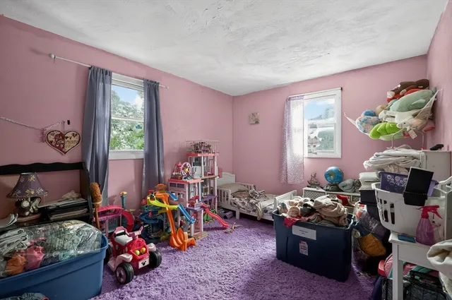 a bed room with furniture and a window