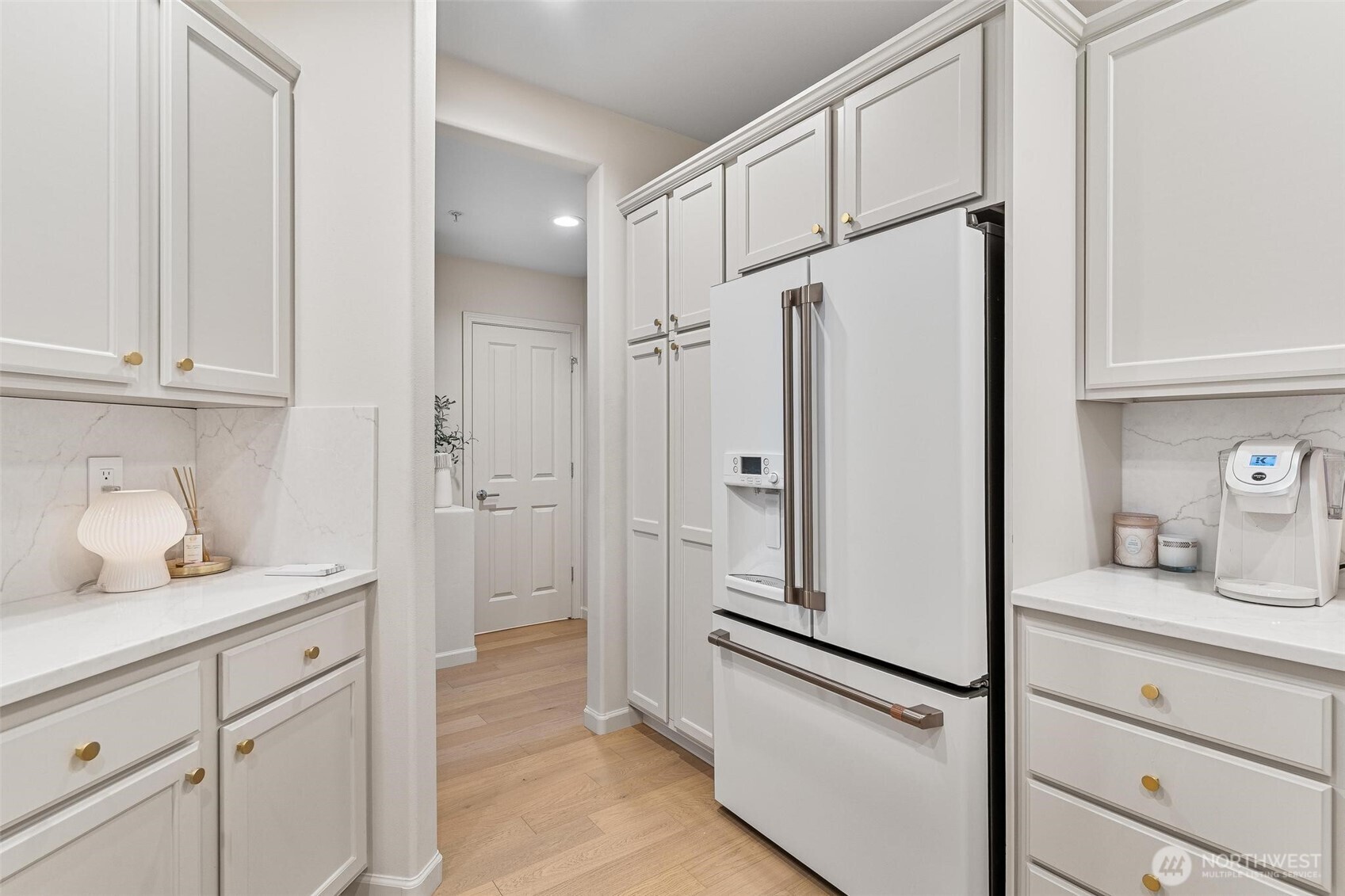 8502 Main Street, Unit E105 Edmonds, WA 98026 - Photo 13 of 39 a kitchen with cabinets and a refrigerator