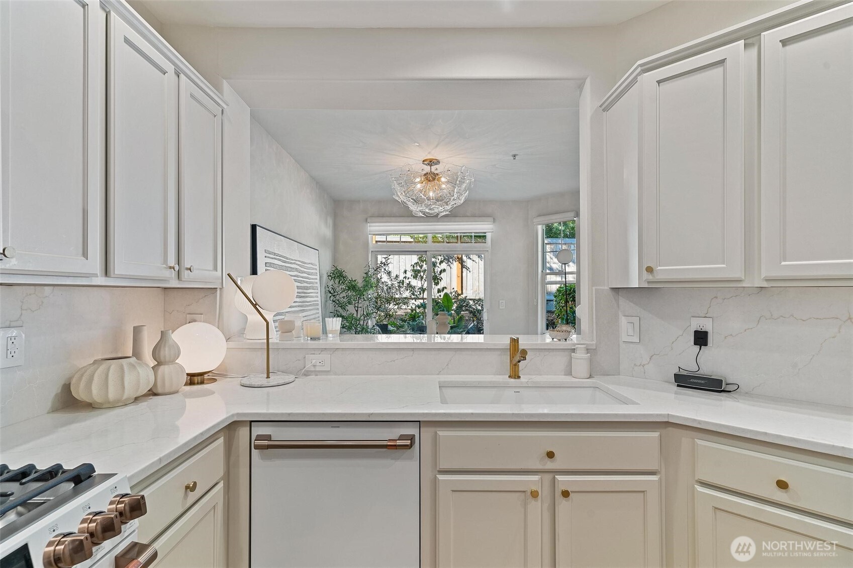 8502 Main Street, Unit E105 Edmonds, WA 98026 - Photo 16 of 39 a kitchen with stainless steel appliances granite countertop a sink a window and cabinets