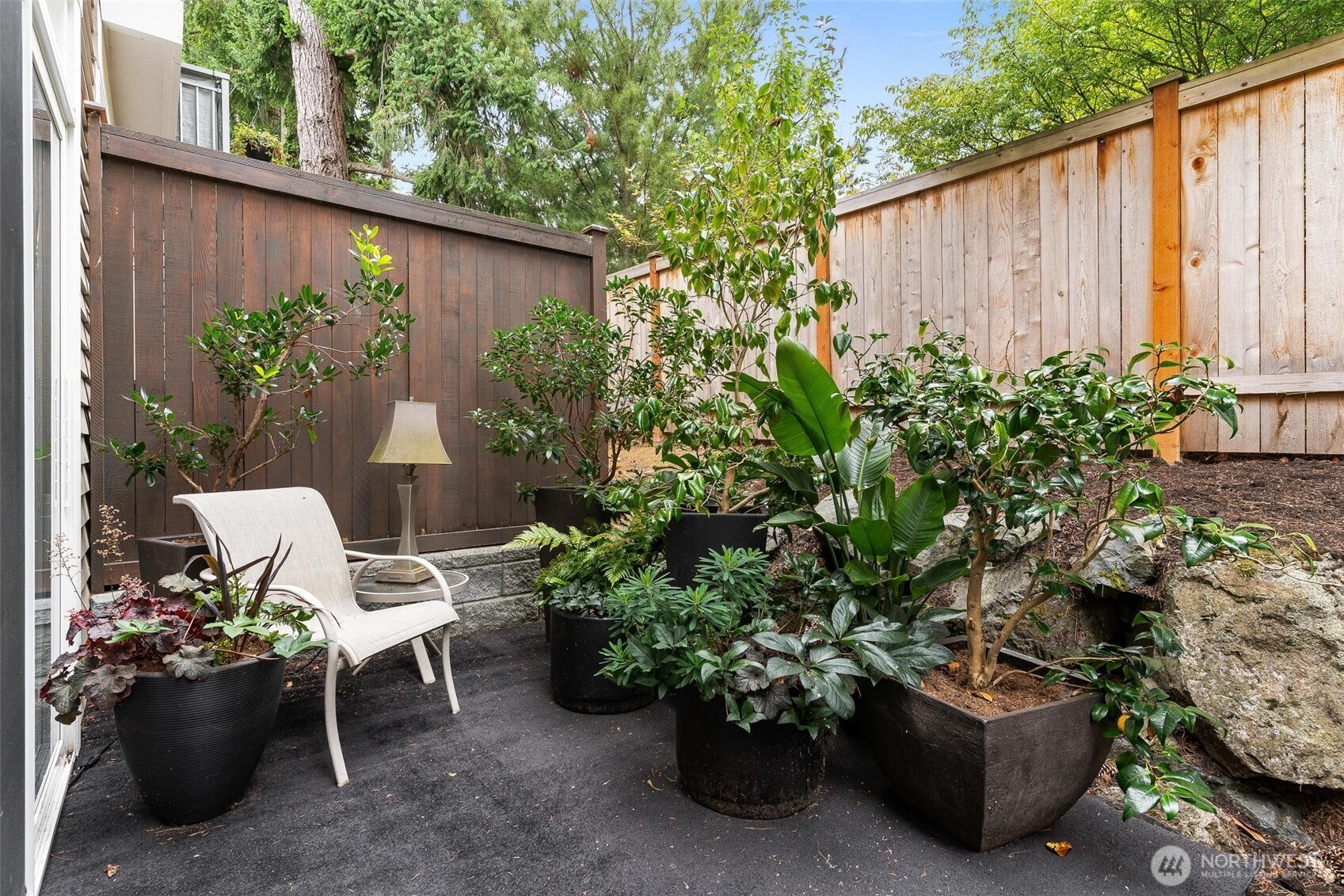 8502 Main Street, Unit E105 Edmonds, WA 98026 - Photo 18 of 39 a view of a backyard with furniture and a garden