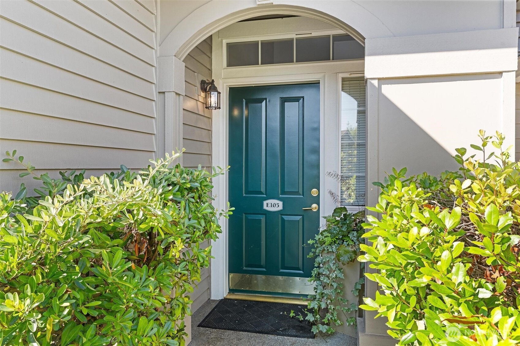 8502 Main Street, Unit E105 Edmonds, WA 98026 - Photo 2 of 39 a front view of a house with a yard