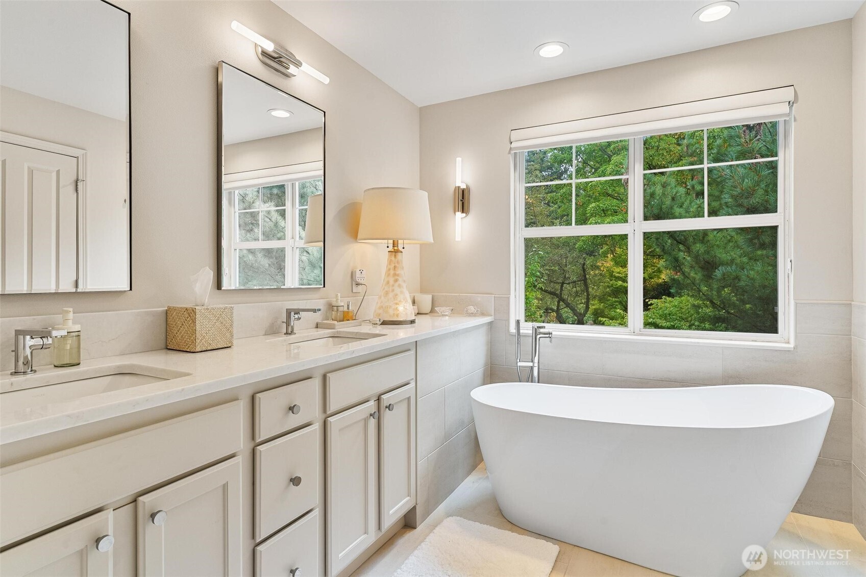 8502 Main Street, Unit E105 Edmonds, WA 98026 - Photo 26 of 39 a bathroom with a white tub a sink and a window