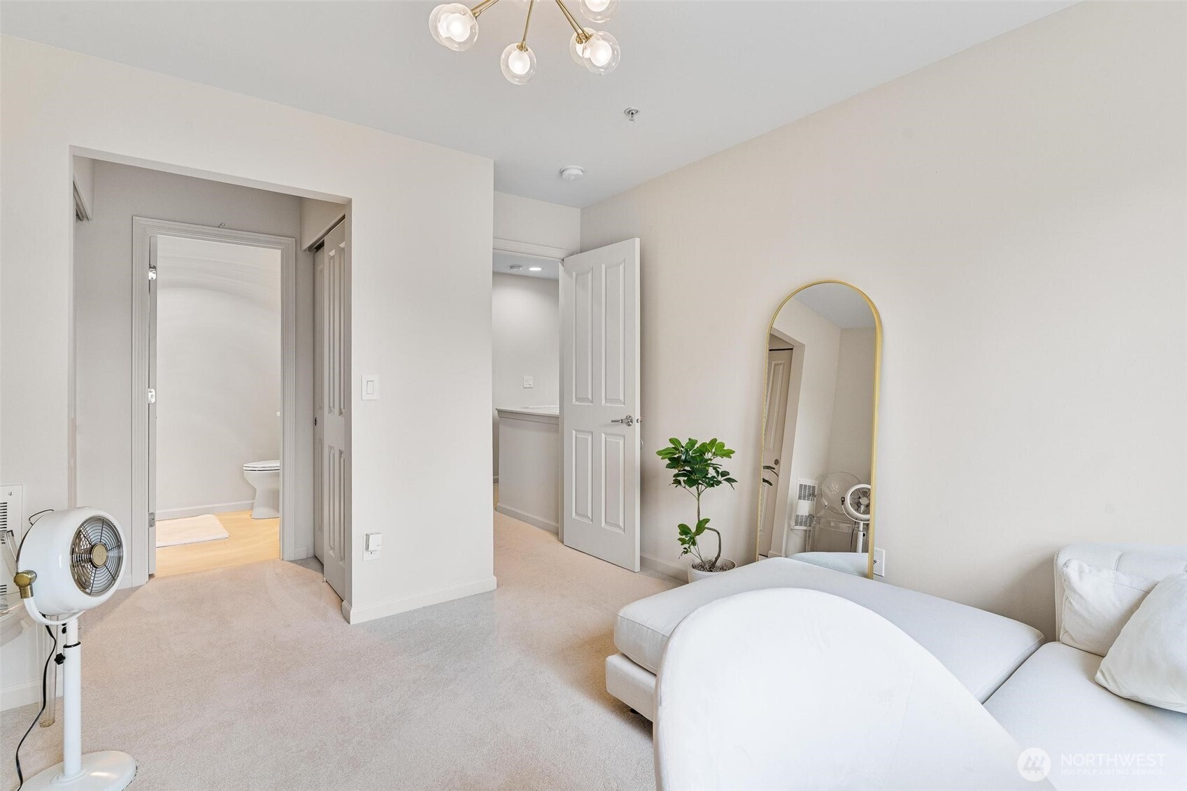 8502 Main Street, Unit E105 Edmonds, WA 98026 - Photo 29 of 39 a bedroom with a bed and a chandelier