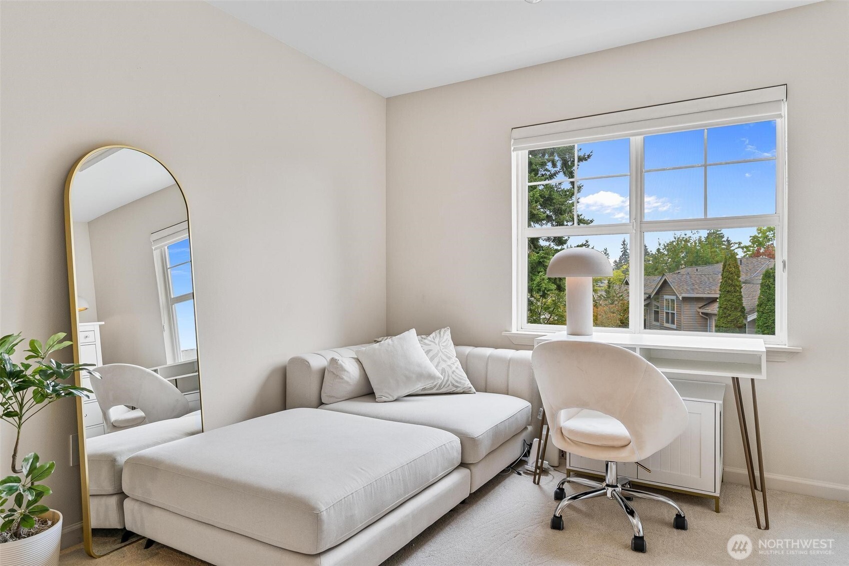 8502 Main Street, Unit E105 Edmonds, WA 98026 - Photo 30 of 39 a living room with a couch and a window