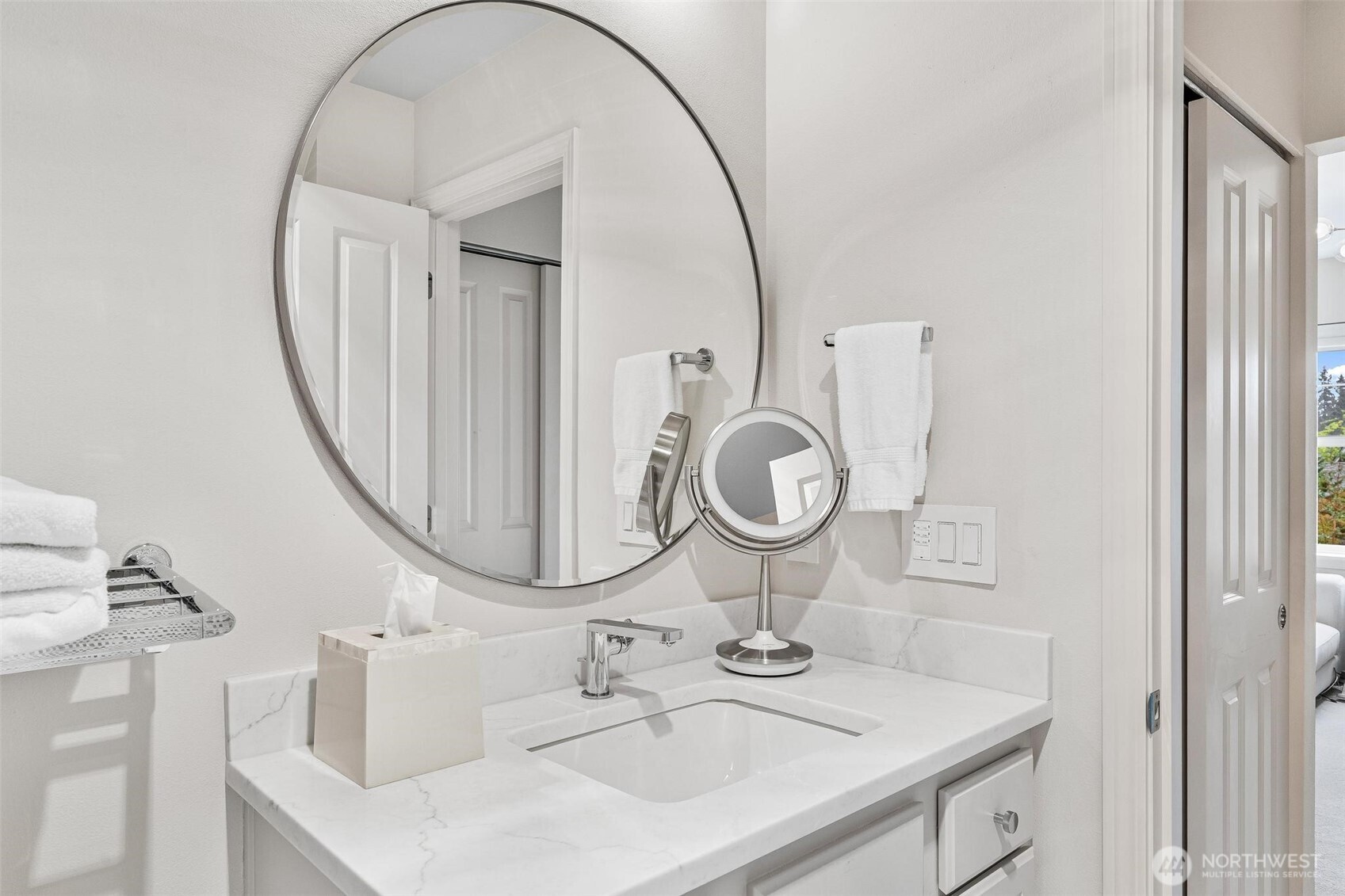 8502 Main Street, Unit E105 Edmonds, WA 98026 - Photo 32 of 39 a bathroom with a sink and a mirror