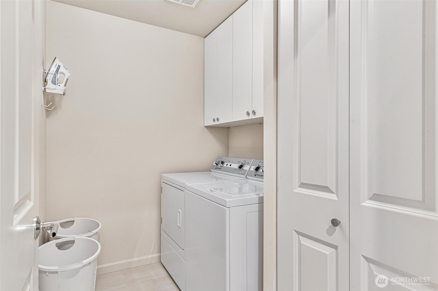 8502 Main Street, Unit E105 Edmonds, WA 98026 - Photo 34 of 39 a bathroom with a sink a toilet and a mirror