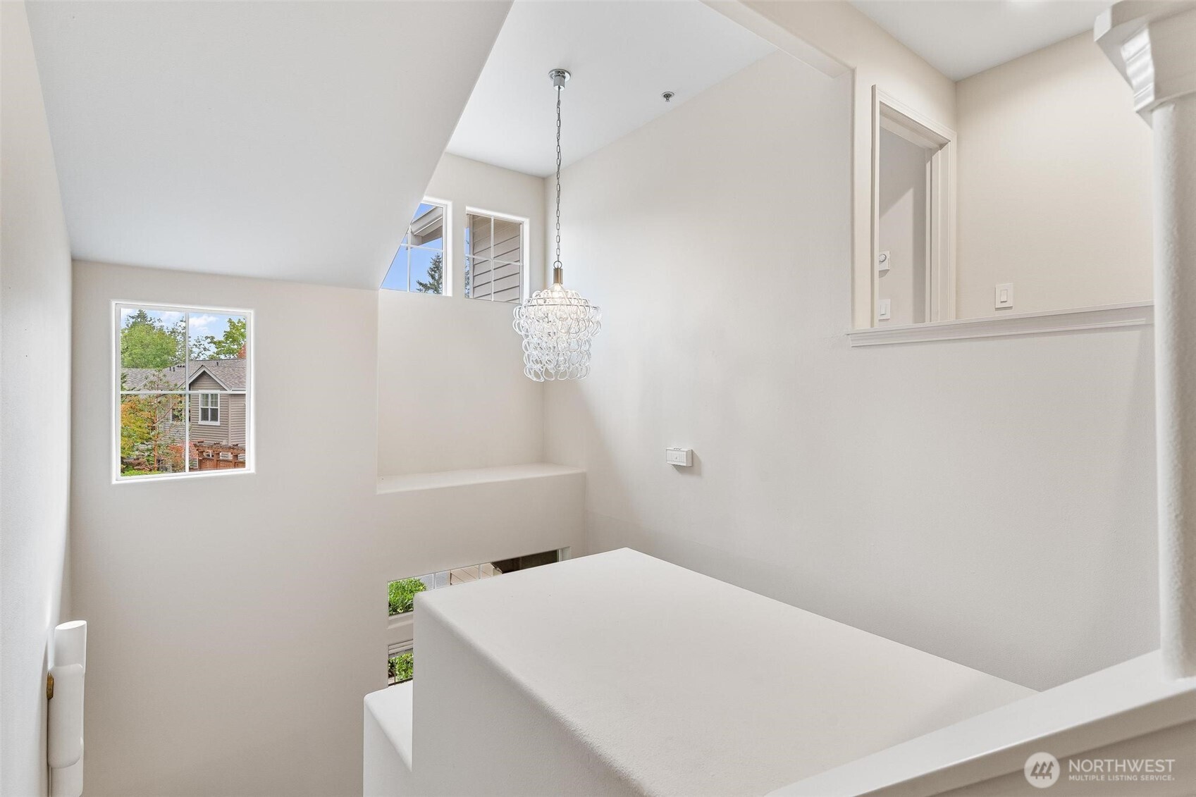 8502 Main Street, Unit E105 Edmonds, WA 98026 - Photo 35 of 39 a room with a white bed and a window