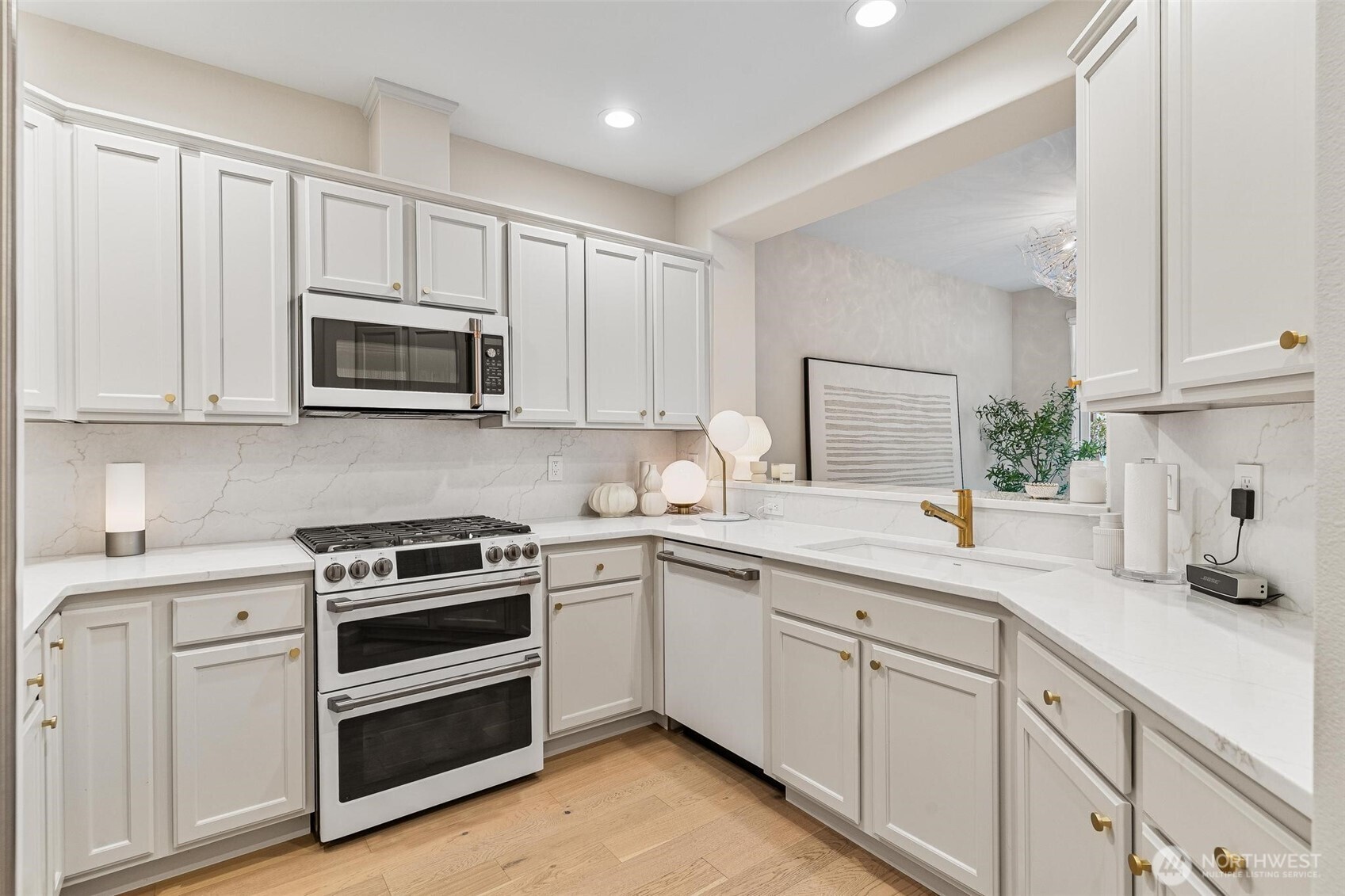 8502 Main Street, Unit E105 Edmonds, WA 98026 - Photo 9 of 39 a kitchen with appliances a sink and cabinets
