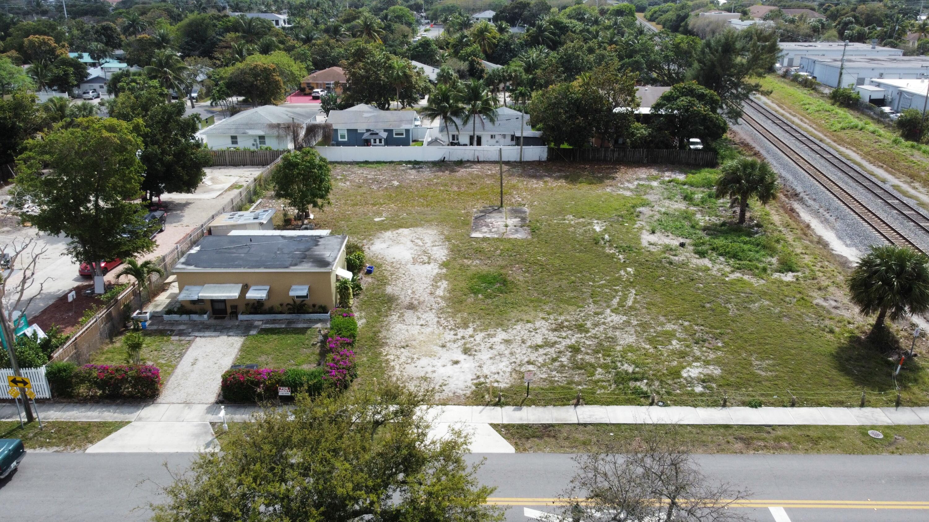 198 Southeast 4th Street Delray Beach, FL 33483 - Photo 3 of 6 a view of swimming pool with seating area and trees in the background