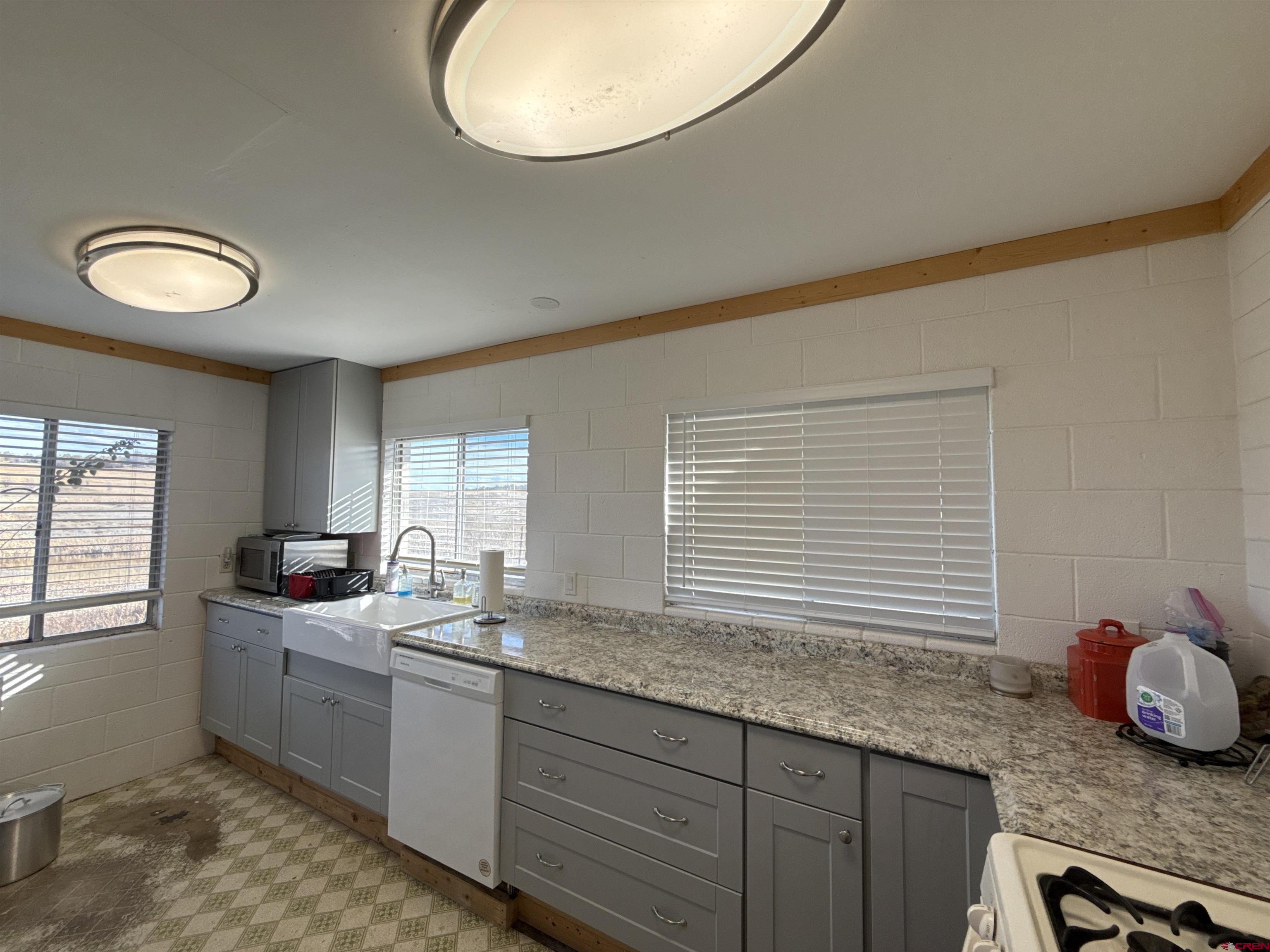 8257 Highway 172 Ignacio, CO 81137 - Photo 15 of 34 a kitchen with granite countertop a sink a window cabinets and stainless steel appliances