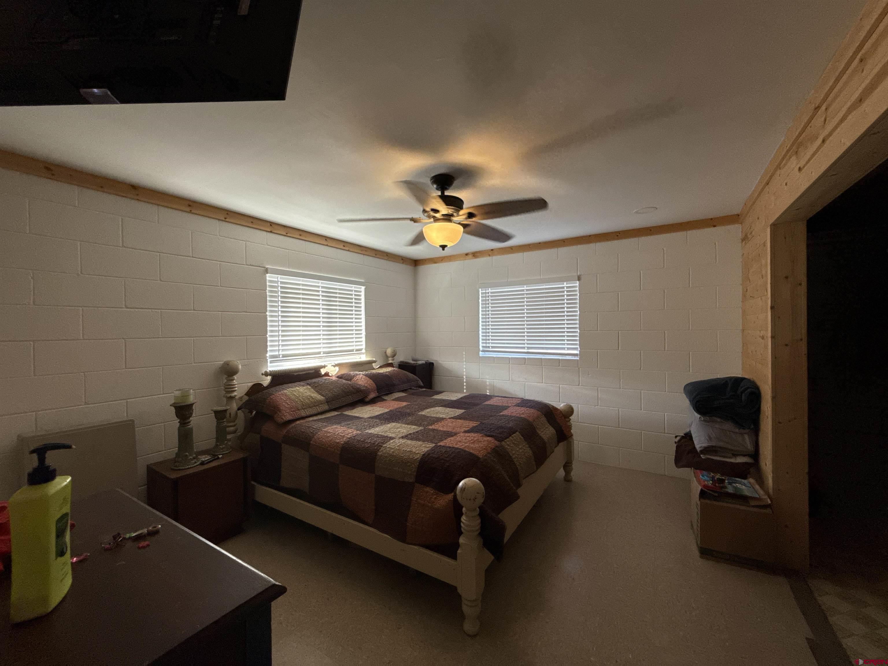 8257 Highway 172 Ignacio, CO 81137 - Photo 16 of 34 a bedroom with a bed and a chandelier