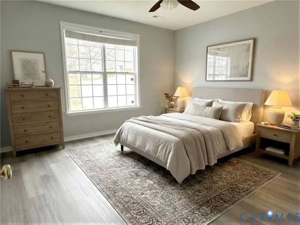 a bedroom with a bed a dresser and next to a window
