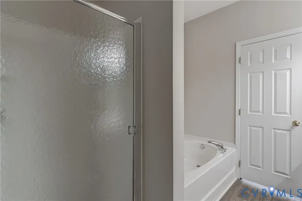 a bathroom with a tub and shower