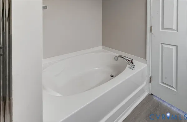 a white bath tub sitting in a bathroom