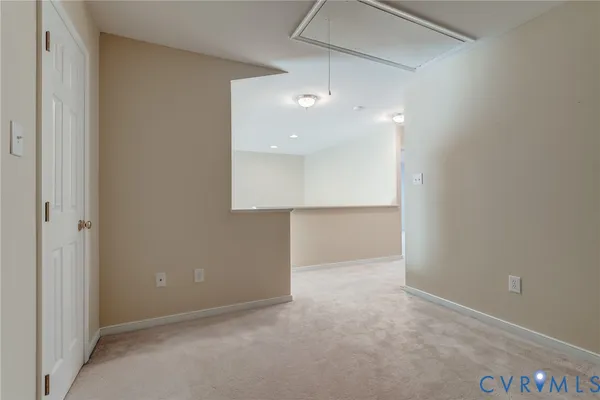 an empty room with cabinet and a chandelier fan