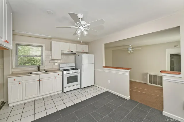 a kitchen with a stove a sink and a refrigerator