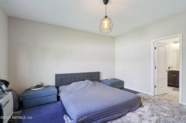 a bathroom with double vanity and a mirror