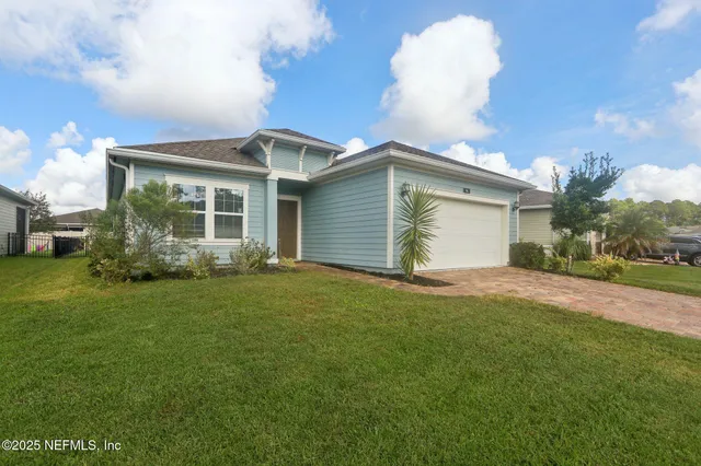 a front view of house with yard and green space