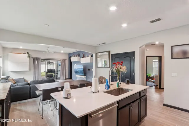 a view of a hallway with workspace and a window