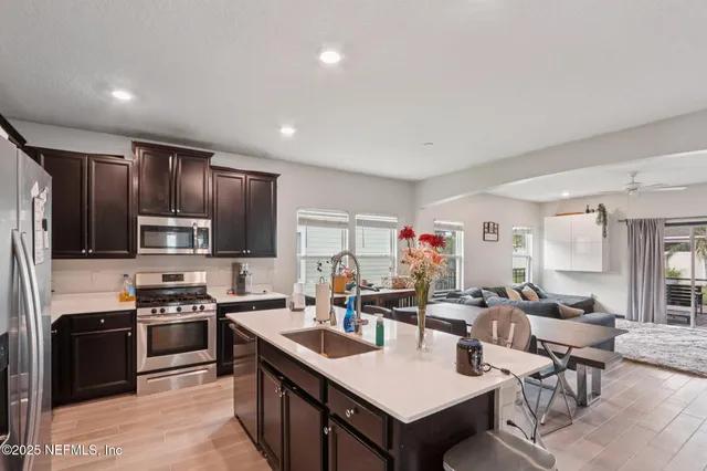 a kitchen with a sink cabinets and window