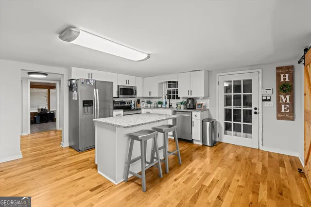 a kitchen with stainless steel appliances granite countertop a refrigerator stove oven and a sink