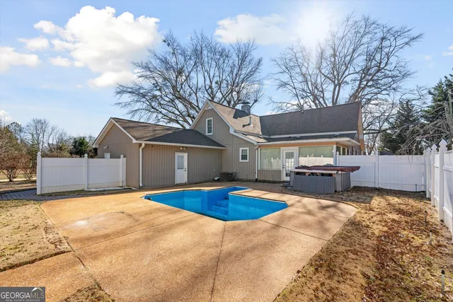 a view of a patio with table and chairs a barbeque with wooden fence