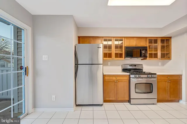a kitchen with stainless steel appliances granite countertop a refrigerator and a stove